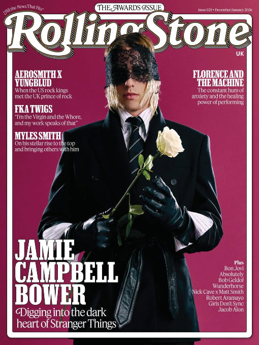 Rolling Stone magazine cover featuring Jamie Campbell Bower with a rose against a pink background